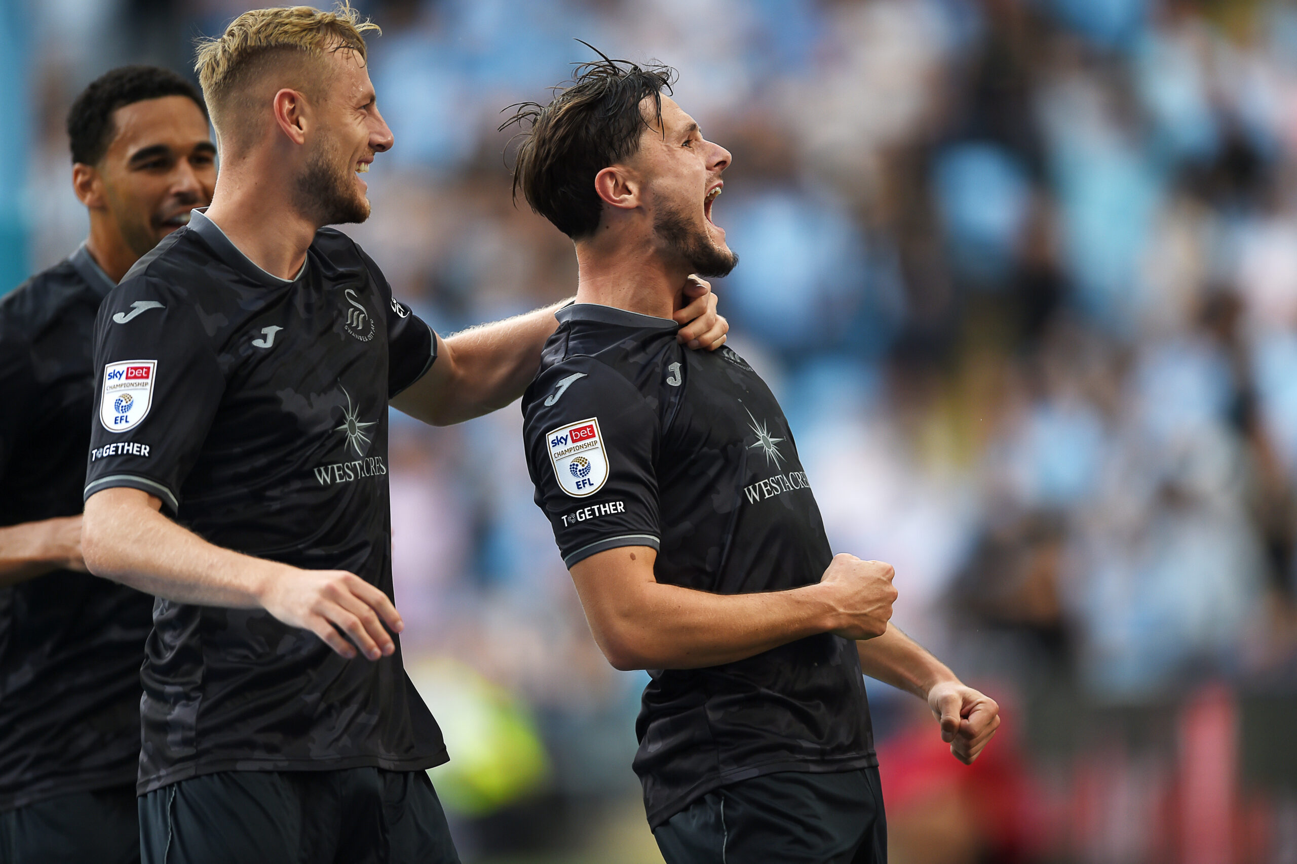 Liam Cullen celebrates with his teammates after he opens the scoring for Swansea.