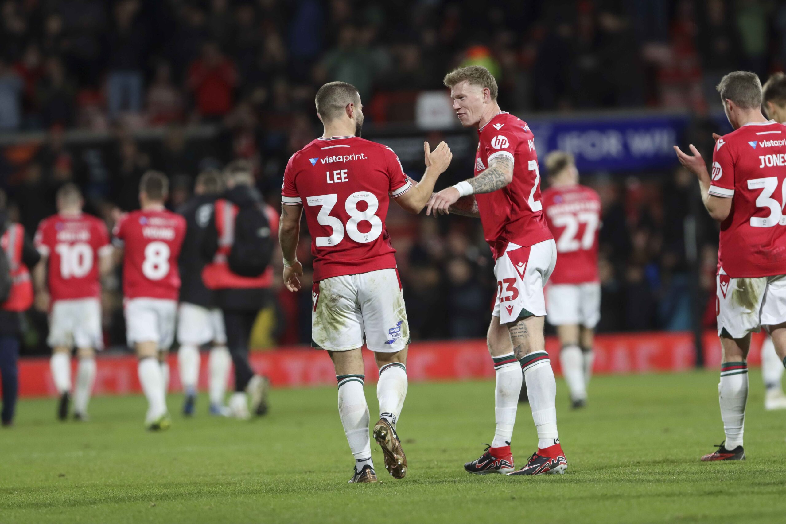 Elliot Lee and James McClean celebrate the Wrexham win.