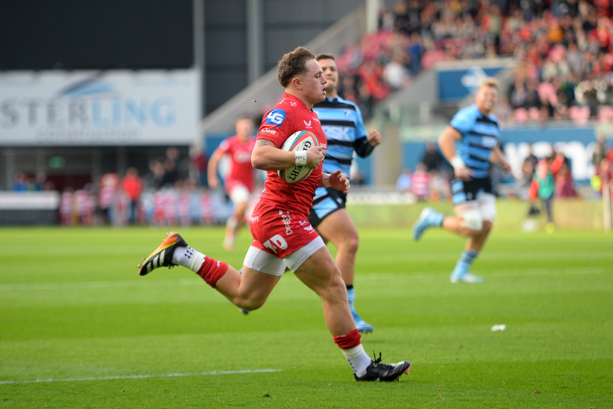 Scarlets' Macs Page runs in to score an early try against Cardiff.